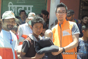 ネパール大地震の被災者に支援物資を届ける坂スタッフ