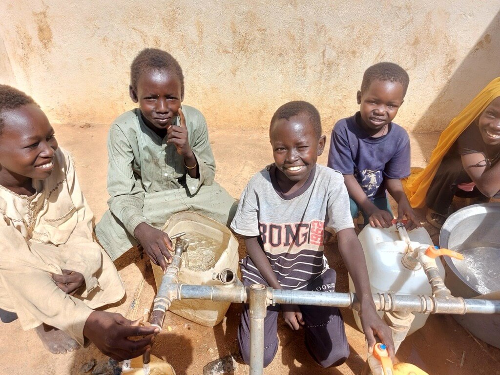 支援により修繕した給水所を使う避難民の子どもたち