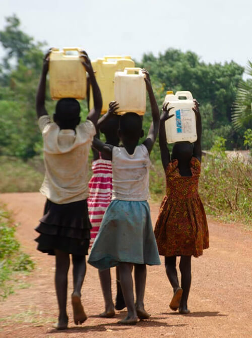 ウガンダでワールド・ビジョンが建設した給水所から水を運ぶ子ども