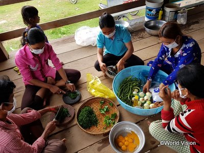 栄養価の高い食事の調理デモンストレーションの活動に参加した子どもたちおよび保護者たち